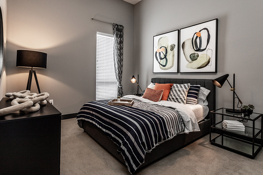 Bedroom with light fixtures at Spark Apartments.