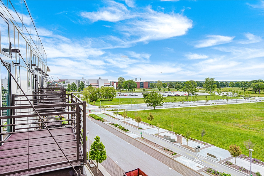 A row of top-story apartment balconies and the view beyond