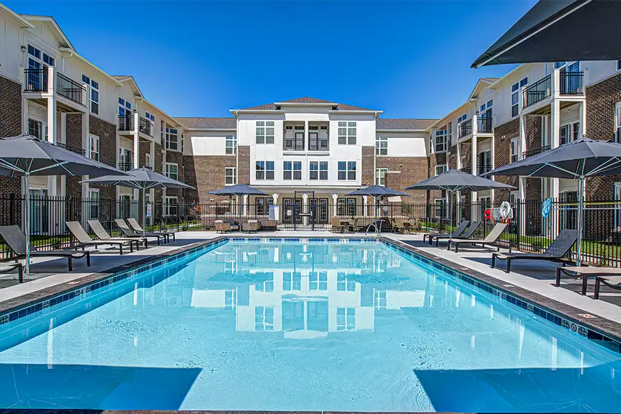 Pristine pool surrounded by apartment buildings at Midtown Flats Apartments.